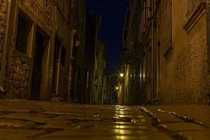 szene einer gepflasterten straße im historischen zentrum von rovinj in kroatien während der nacht foto