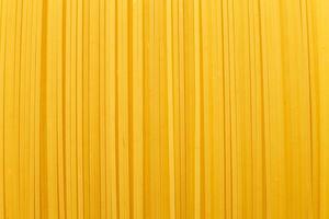 Spaghetti gelben Hintergrund schließen. Rohe Nudeln Makro foto