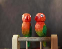 Paar lustige Lovebird-Papageien, geschnitztes Holzspielzeug foto