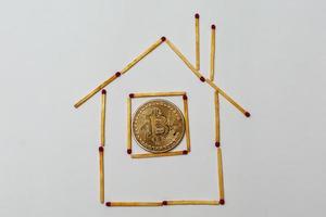 Goldenes Bitcoin auf isolierendem weißem Hintergrundkonzept Bergbauhaus, Wohnung, Kauf, foto