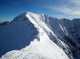 herrliche aussicht auf verschiedene berggipfel mit schnee im winter. wunderschöne Bergkette und erstaunliche Attraktion für alpine Kletterer. abenteuerlicher Lebensstil. anspruchsvoller Berggrat für Kletterer. foto