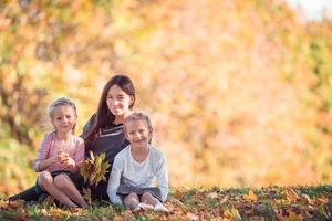 kleines Mädchen mit Mutter draußen im Park am Herbsttag foto