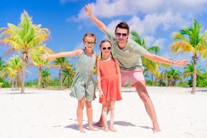 vater und kinder genießen sommerferien am strand foto