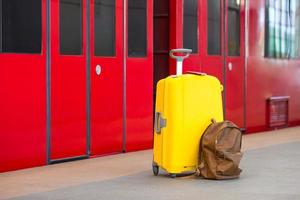 Gelbes Gepäck mit Pässen und braunem Rucksack am Bahnhof foto