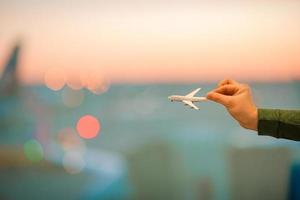 Nahaufnahmehand, die ein Flugzeugmodell hält foto