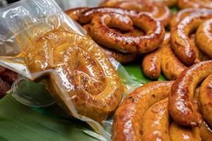 Eingewickelte Verpackung von Sai Aua, würzige Wurst aus Nordthailand, eine berühmte traditionelle lokale Saurage, die mit Curry und Kräutern im Geschäft gekocht wird und zum Verkauf bereit ist. foto