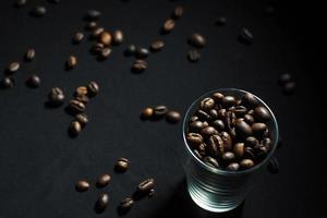 Kaffeebohnen in einem Glas auf schwarzem Hintergrund foto