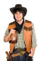junger Cowboy mit einer Flasche foto