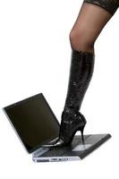 sexy Bein über Laptop. isoliert auf weiß foto