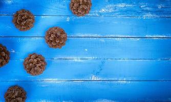 Blauer Holzhintergrund mit Tannenzapfen foto