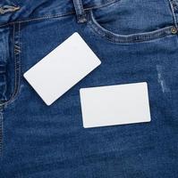 leere Weißbuchvisitenkarten auf einem Blue Jeanshintergrund foto
