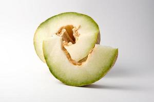 Stück reife Melone mit Samen auf weißem Hintergrund foto
