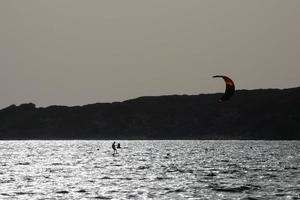 Windsurfen, Kitesurfen, Wasser- und Windsport mit Segeln oder Drachen foto