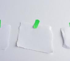 abgerissenes weißes Stück Papier auf grünen Klettverschluss geklebt foto