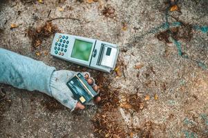 Bettler schläft auf der Straße mit Kreditkartenautomat foto