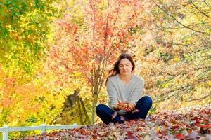 fröhliche Frau, die sich am schönen Herbsttag entspannt, foto