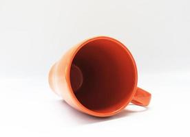 orange Kaffeetasse auf der Seite foto