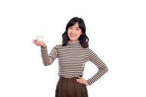 Porträt von jung asiatisch Frau beiläufig Uniform halten Weiß Schweinchen Bank isoliert auf Weiß Hintergrund, finanziell und Bank Speichern Geld Konzept foto