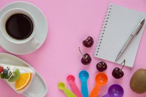 Draufsicht auf Schreibtisch mit Kaffee und Dessert