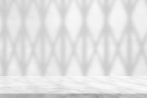 Weiß Marmor Tabelle mit Schatten von falten Tür auf Beton Mauer Hintergrund, geeignet zum Produkt Präsentation Hintergrund, Anzeige, und spotten hoch. foto
