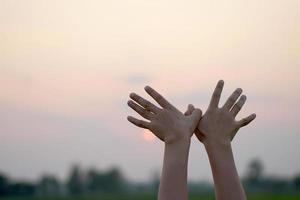 Mensch Hand Silhouette von fliegend Vogel Sonnenuntergang Hintergrund foto