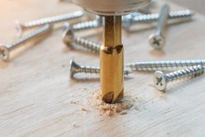 Zimmermann verwenden versenken bisschen zu bohren beide ein Pilot Loch und verwenden versenken bisschen zu Pause das Kopf von das Schraube in Holz Planke. DIY Hersteller und Holzbearbeitung Konzept. selektiv Fokus foto