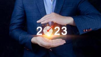 Geschäft Ziel und Tor 2023 Symbol, Hand zeigen halten 2023 virtuell Bildschirm, Start Neu Jahr 2023 mit ein Tor planen, Aktion planen, Strategie, Neu Jahr Geschäft Vision. foto