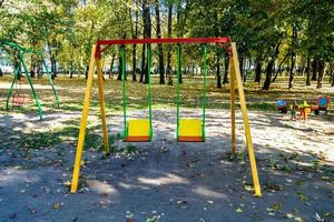 Fotografie zum Thema leerer Spielplatz mit Metallschaukel für Kinder foto