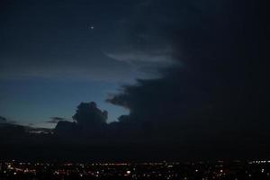 dunkel Blau Wolke mit Weiß Licht Himmel Hintergrund und Stadt Licht Mitternacht Abend Zeit foto