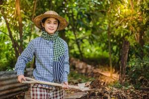 jung ziemlich Farmer Frau Stehen auf Ackerland und inspizieren landwirtschaftlich Pflanzen foto