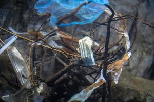 Plastik und covid Maske Abfall unter Wasser foto