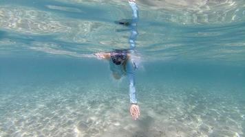 Mädchen Schwimmen unter Wasser im Kristall Türkis Lagune foto