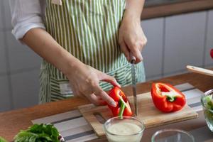 jung Frau vorbereiten Glocke Pfeffer wie ein Frühstück Zutat und bereit zum gesund Kochen und auf das Tabelle Dort sind Gemüse Das sind gesund organisch Zutaten. gesund Essen Vorbereitung Ideen foto