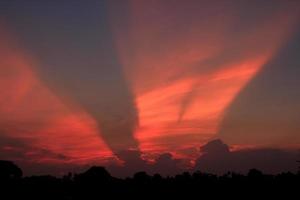 Atmosphäre im das Abend Himmel wie das Sonne setzt - - Balken - - von das Sonne und Wolken erstellen schön Farben und viele Farben, Erstellen ein warm und romantisch Atmosphäre auf ein Sommer- Abend. foto