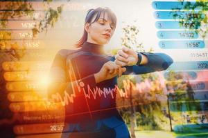 Frau prüft ihr Fitness Uhr während ausüben draussen im ein sonnig Tag foto