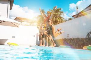 Gruppe von freunde im Badeanzug genießen im ein Schwimmen Schwimmbad foto