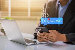 Geschäftsmann mit Smartphone mit Neu Email aufmerksam. Kommunikation Verbindung Mitteilungen im global Arbeitsplätze durch Email Marketing oder Digital Newsletter foto