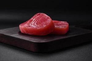zwei frisch Scheiben von roh Thunfisch Filet mit Gewürze und Kräuter foto