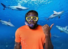 erschrocken Mann mit Maske unter Wasser umgeben durch Haie foto