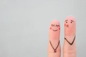 Finger Kunst von glücklich Paar. Konzept von Mann weht Kuss, Frau ist beschämt. foto