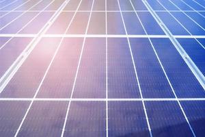 schließen oben von Vorderseite Aussicht Blau Solar- Panel mit Sonnenlicht Strahl und Wolke Betrachtung. Solar- Zelle Technologie, Leistung Zelle Alternative Quelle von Elektrizität. Photovoltaik Zelle Tafel. sauber Energie Leistung Konzept foto