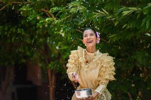 Portrait schöne Frau beim Songkran-Festival mit traditioneller thailändischer Tracht foto