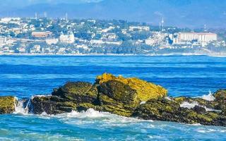 schöne felsen klippen surfer wellen am strand puerto escondido mexiko. foto