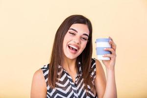 Kaffee Liebhaber Konzept. Nahansicht Foto Porträt von herrlich heiter positiv mit zahnig strahlend Lächeln Person halten Tasse von warm Latté im Hände kuscheln zu Sie selber isoliert hell Farbe Hintergrund