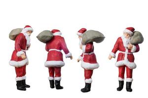 Miniatur-Weihnachtsmann, der eine Tasche trägt, die auf einem weißen Hintergrund lokalisiert wird foto