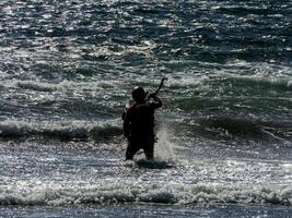 Kitesurfer beim Sonnenuntergang foto