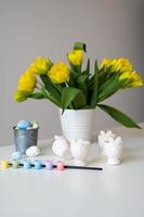 Vase mit schön Blumen, Ostern Hase Halter mit Eier, Farben und pinsel.vertikal Banner foto