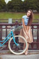 jung elegant gekleidet Frau mit Fahrrad, Sommer- und Lebensstil foto