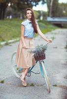 jung elegant gekleidet Frau mit Fahrrad, Sommer- und Lebensstil foto