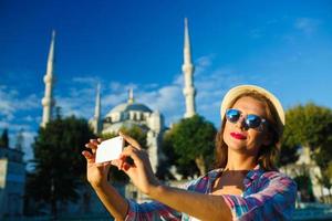 Mädchen Herstellung Selfie durch das Smartphone auf das Hintergrund von das Blau Moschee, Istanbul. Truthahn foto